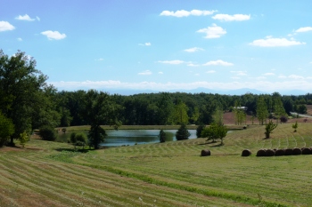 Paysage rural avec lac et bottes de foin, Office de Tourisme Cœur de Garonne