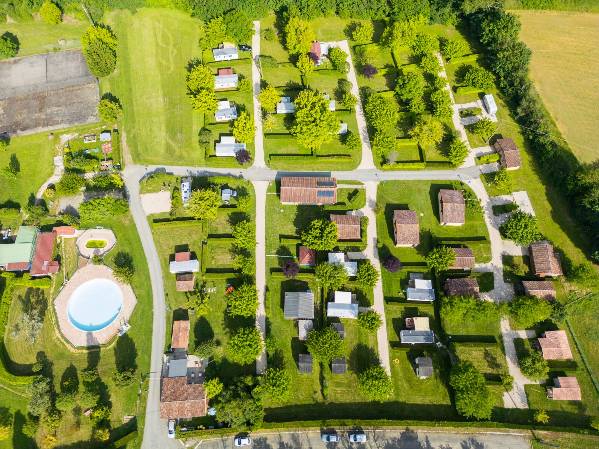 Vue aérienne d’un camping avec mobil-homes et piscine en Cœur de Garonne