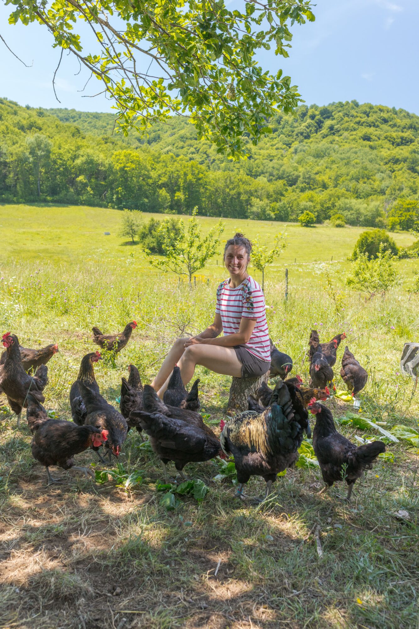 Fermière assise parmi des poules, Office de Tourisme Cœur de Garonne